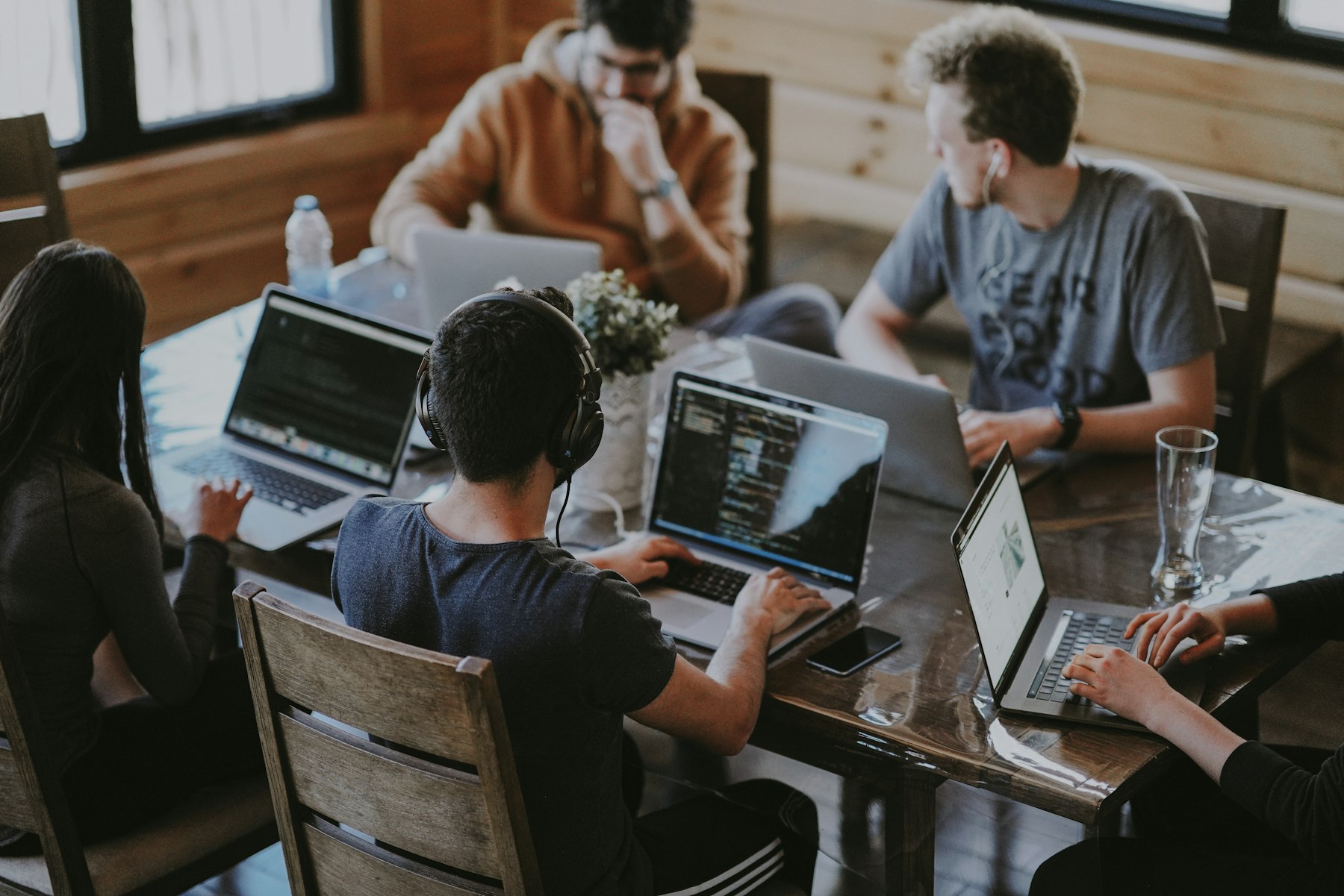 Teams working on laptops in a Microsoft 365 workplace